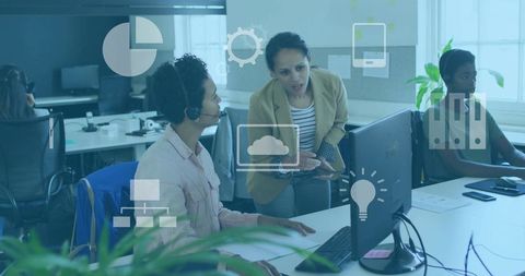Team leader mentoring call center agent at desktop with cloud technology icons