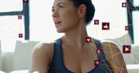 Contemplating woman in athleisure with connected digital fitness icons, modern wellness