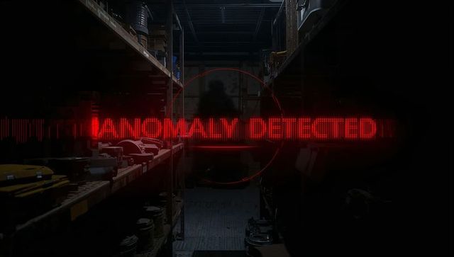 Silhouetted intruder in warehouse aisle with red hud reticle and anomaly detected alert