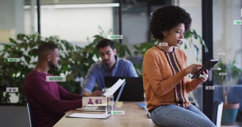 Team Collaborating in Modern Office with Technology and Documents