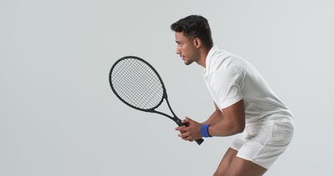 Focused Tennis Player Preparing to Serve on Neutral Background