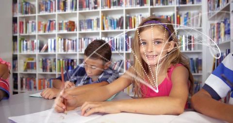 Smiling girl writing in library study group with notebooks and books, learning moment