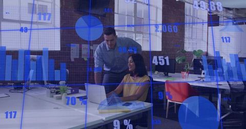 Business team analyzing data on laptop with blue analytics overlay in open-plan office