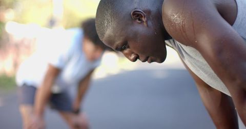 Exhausted Athletes Taking a Break on Sunlit Path