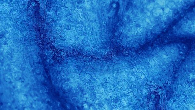 Blue topographic texture revealing organic rings, speckles and curved marble patterns