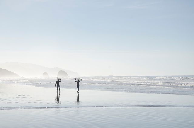 2 Person Holding Surfboard Walking Near Beach - Download Free Stock Photos Pikwizard.com