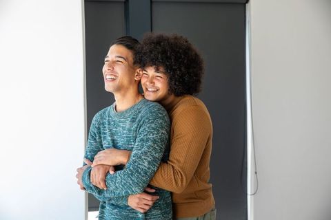 Multicultural Friends Embracing in Contemporary Home Interior