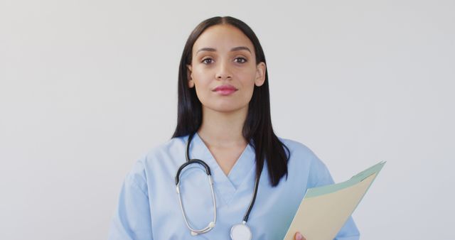 Confident Female Nurse Holding Medical Documents in Scrubs - Download Free Stock Images Pikwizard.com