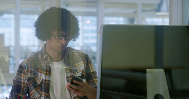 Focused Young Man Using Smartphone in Modern Office Environment - Download Free Stock Images Pikwizard.com