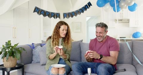 Mature Couple Enjoying Birthday Celebration in Living Room