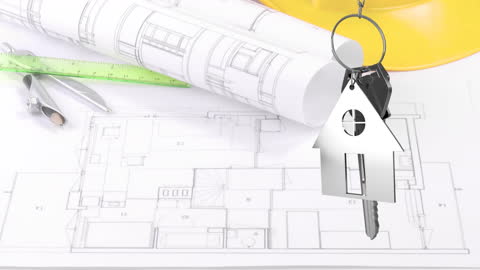 Real Estate Investment Concept with Architectural Plans and Key