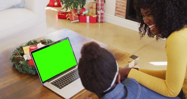 Mother and Daughter Enjoying Christmas Together Watching Laptop with Green Screen - Download Free Stock Images Pikwizard.com