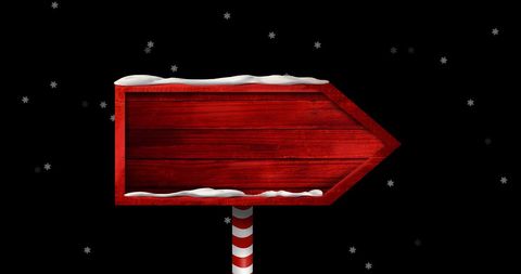 Rustic Red Wooden Direction Sign in Snowy Night