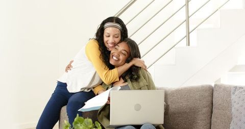 Joyful Friends Video Chatting at Home with Laptop
