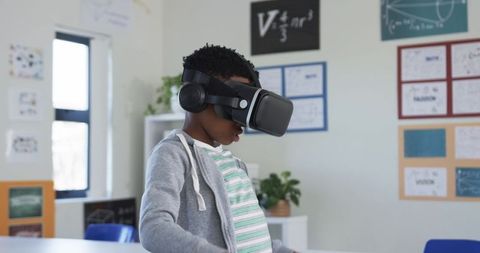 African American Student Exploring STEM with VR Headset in Sunlit Classroom