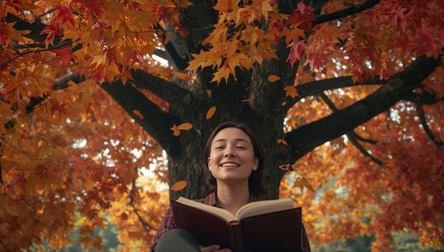 Young Woman Reading Under Colorful Autumn Tree