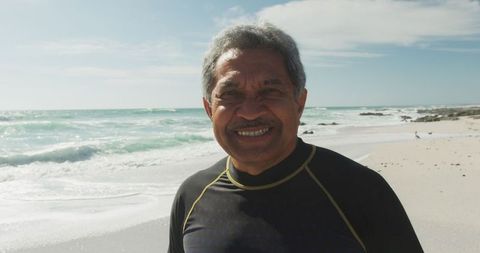 Senior Hispanic Man Smiling on Sunny Beach Day - Download Free Stock Images Pikwizard.com