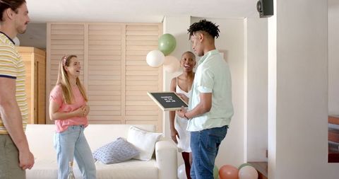 Friends Celebrating at Home with Champagne and Joyful Laughter