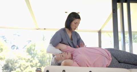 Physiotherapy session with senior woman at home