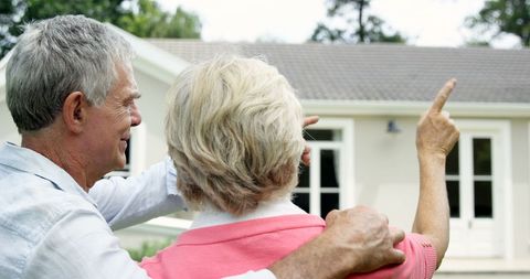 Senior couple planning home purchase outdoors