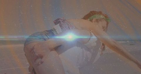 Playful Beach Romance with Lens Flare Effect of Piggyback Ride