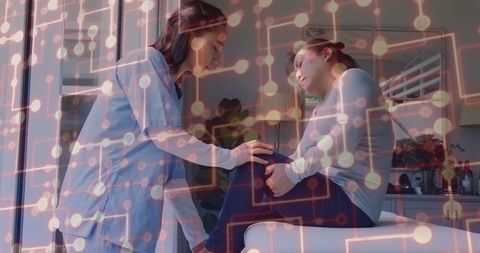 Healthcare professional examining patient's knee in modern medical setting