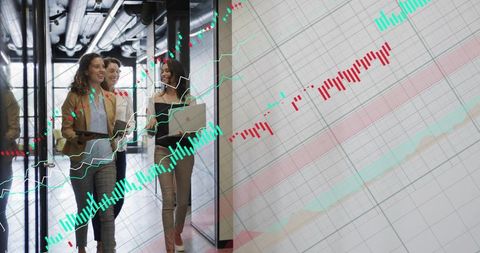 Walking women executives collaborating with laptop and tablet amid financial data overlay