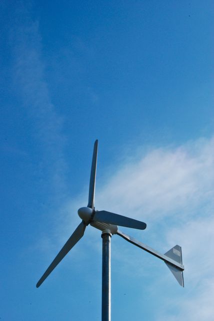 Wind Turbine Against Blue Sky with Clouds - Download Free Stock Photos Pikwizard.com