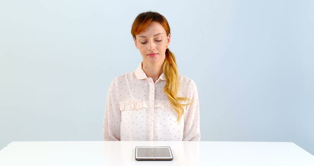 Woman Meditating in Front of Tablet Device on White Table - Download Free Stock Images Pikwizard.com