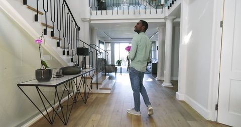 Man Cheering Romance Surprise with Flowers at Home