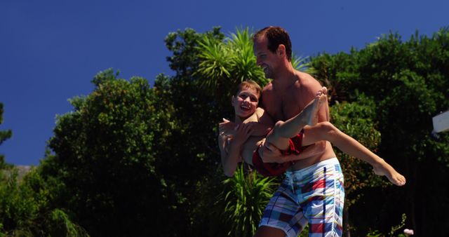 Father Playing and Lifting Son Outdoors on a Sunny Day - Download Free Stock Images Pikwizard.com