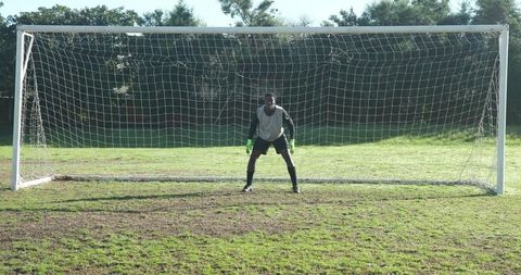 Soccer Goalkeeper Stand on Grass Field Ready for Action