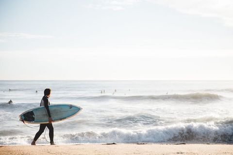 Surfer Walking Towards Ocean with Surfboard, Sunny Beach