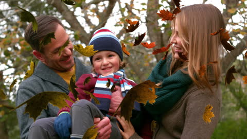 Happy Family Enjoying Autumn in Park