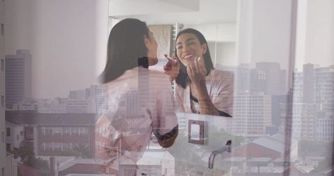 Woman Applying Lipstick Reflected in Mirror Over Cityscape Background