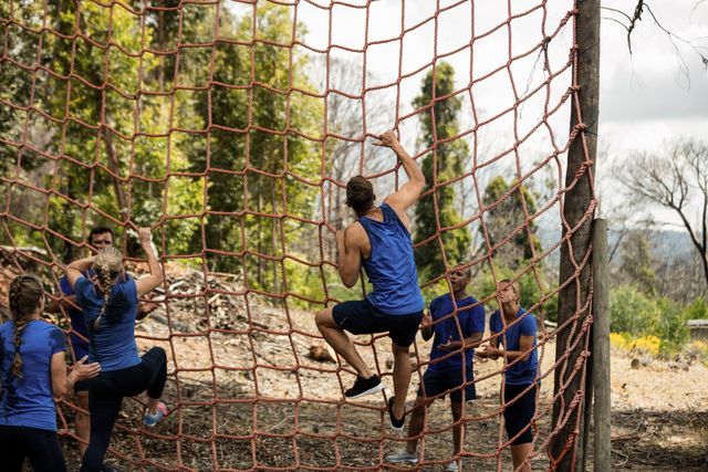 People climbing a net during obstacle course - Download Free Stock Photos Pikwizard.com