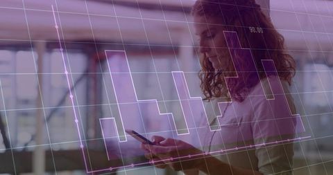 Woman analyzing mobile data with transparent financial graph overlay in modern office