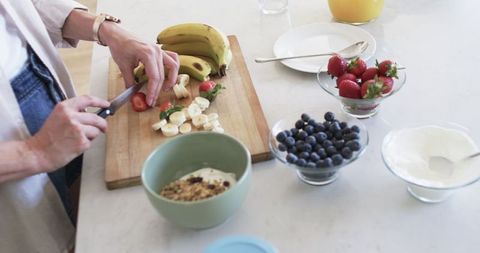 Woman Prepares Healthy Breakfast with Fresh Fruits at Home - Download Free Stock Images Pikwizard.com