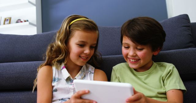 Happy Children Bonding Using Digital Tablet Indoors at Home - Download Free Stock Images Pikwizard.com