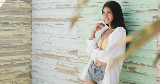 Smiling Woman in Casual Summer Outfit Leaning Against Colorful Wooden Wall - Download Free Stock Images Pikwizard.com