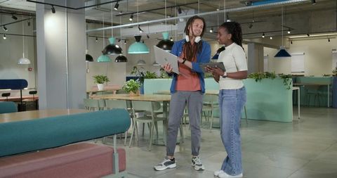 Young African American Coworkers Collaborating in Modern Pastel Open Coworking Space