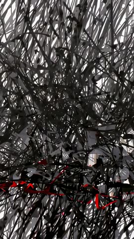 Vertical video showing abstract black wire network with red strand in minimalist interior