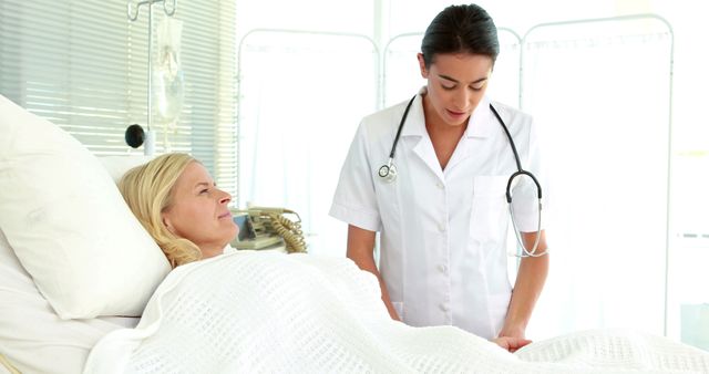 Female Nurse Checking on Blonde Patient in Hospital Bed - Download Free Stock Images Pikwizard.com