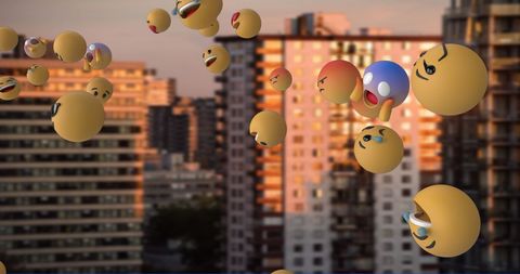 Floating emoticons above urban cityscape at sunset