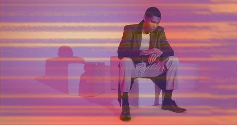 Elegant man in studio lighting checking wristwatch