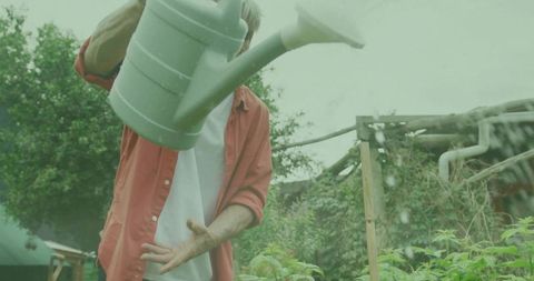 Watering Garden with Green Watering Can Enhancing Plant Growth