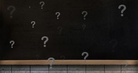 Question marks on blackboard symbolizing curiosity and learning