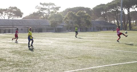 Youth soccer players performing during sunny field match