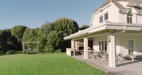 Charming two-story house with pergola and green backyard