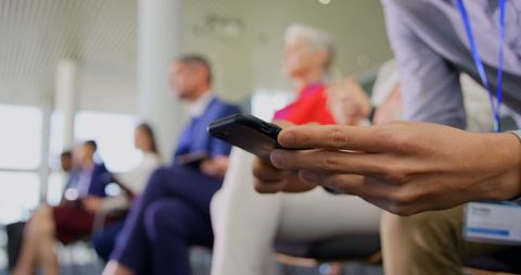 Businessman Using Smartphone at Corporate Seminar - Download Free Stock Images Pikwizard.com